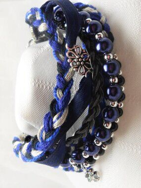 Handmade bracelet with rows of threads, beads, and charms No. 185